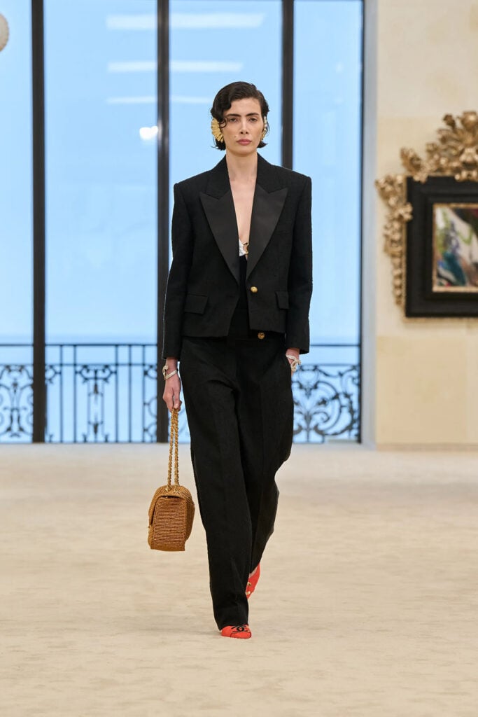 Chanel Resort 2027 black cropped jacket and wide-leg trouser suit on the runway.