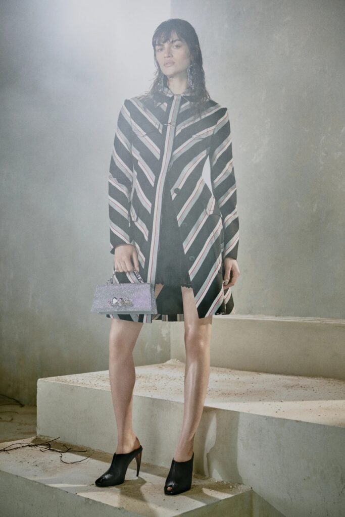 McQueen Pre-Fall 2026 chevron-striped coat and gingham mini dress on the runway.
