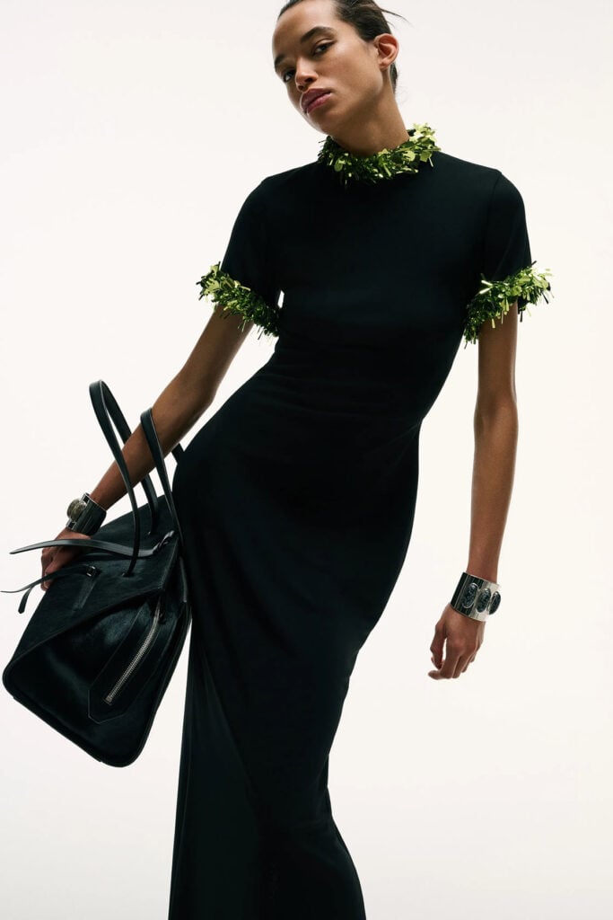 Brandon Maxwell Fall 2026 black gown with green embellished neckline and sleeve detailing on the runway