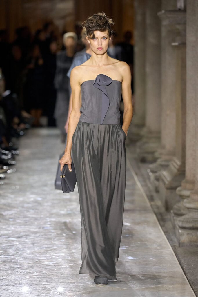 Armani Fall 2026 charcoal-grey strapless top and fluid pleated trousers on the runway