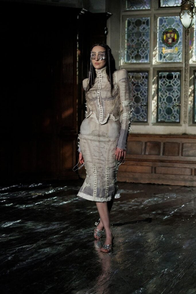 Dilara Findikoglu runway look with distressed sheer construction and exposed seam detailing.
