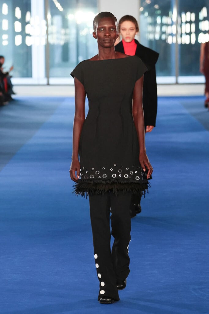 Proenza Schouler Fall 2026 black dress layered over flared trousers on the runway