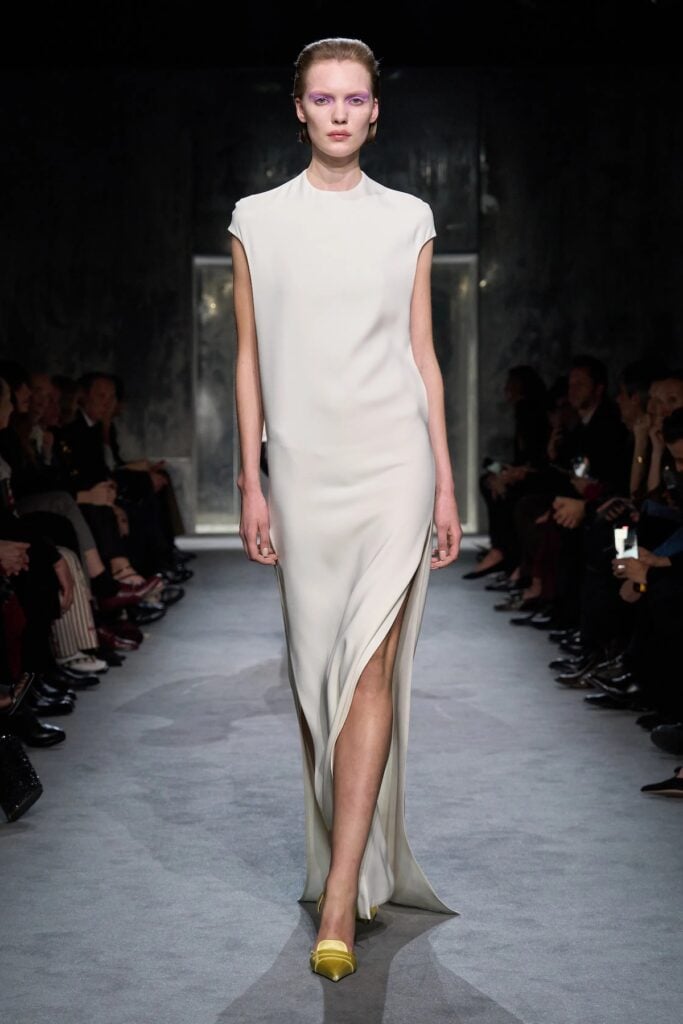 Tom Ford runway gown with draped white styling and minimalist silhouette.