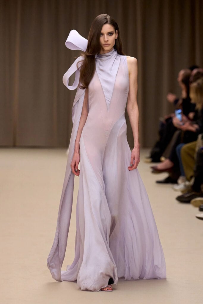 McQueen runway gown featuring lavender tones and sculptural shoulder detailing.
