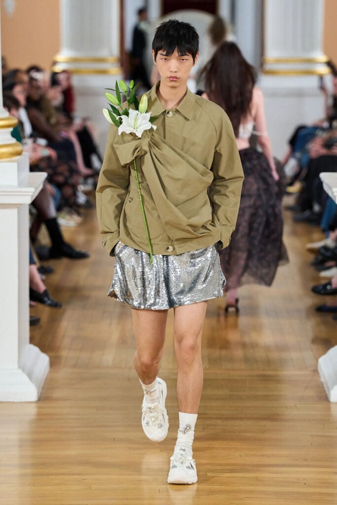 Simone Rocha Spring 2026 gathered flower-sash jacket presented during the runway show.
