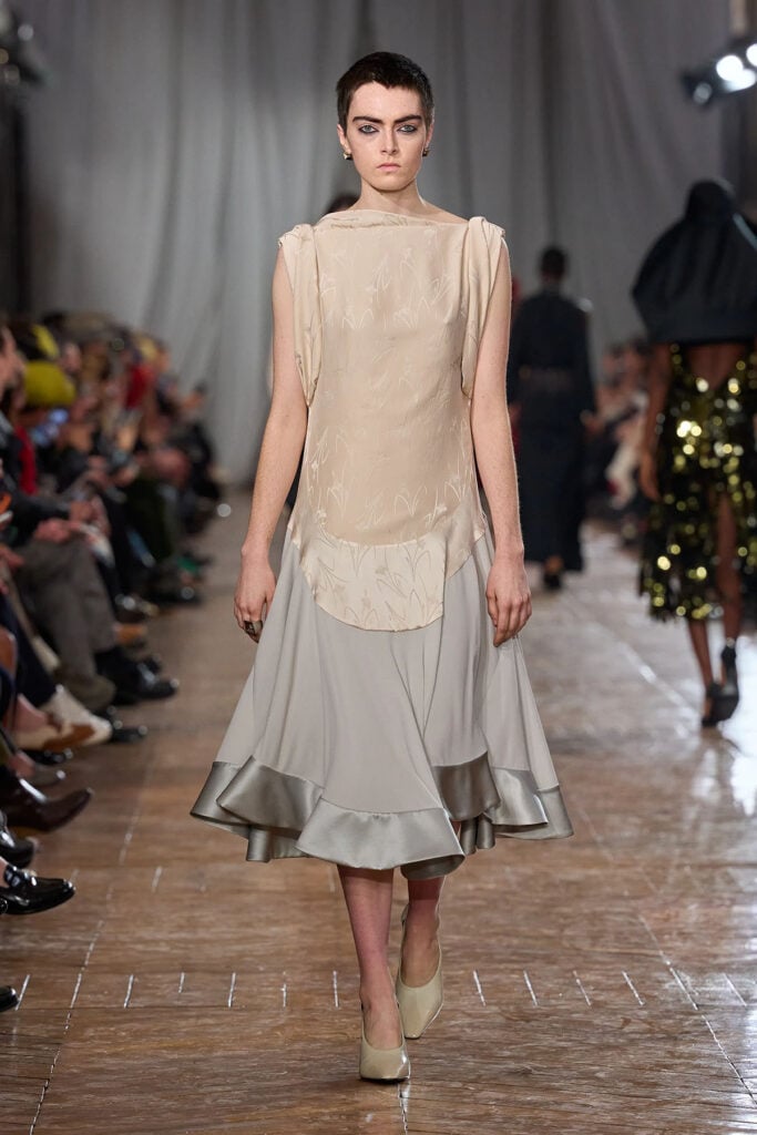 Lanvin Fall 2026 dress by Peter Copping featuring a mixed-media design and soft neutral colour palette on the runway.