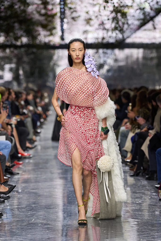 Model walks the Dior Spring 2026 Haute Couture runway in the sculptural pink-and-white embroidered ensemble