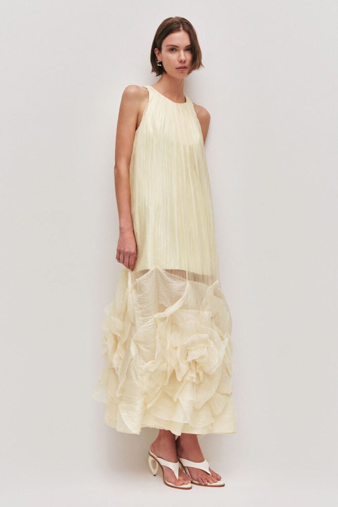 Model wearing the Aje Ecliptica crinkled-ruffled maxi dress from the designer's collection