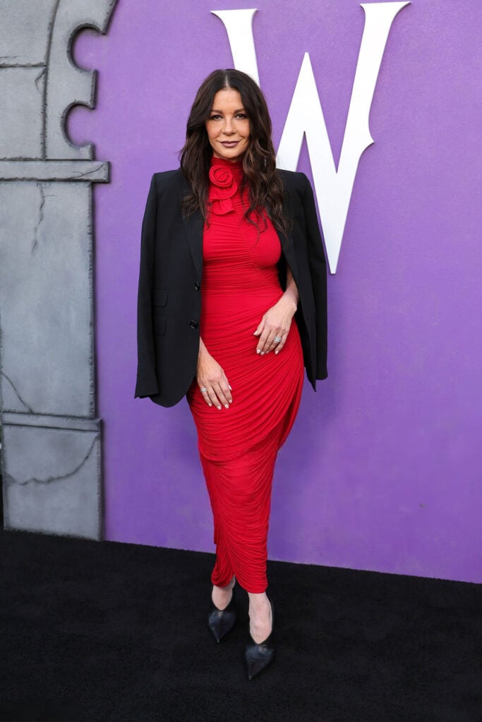 Catherine Zeta-Jones wearing a red Magda Butrym ruched dress at Netflix’s Wednesday FYSEE event in Los Angeles