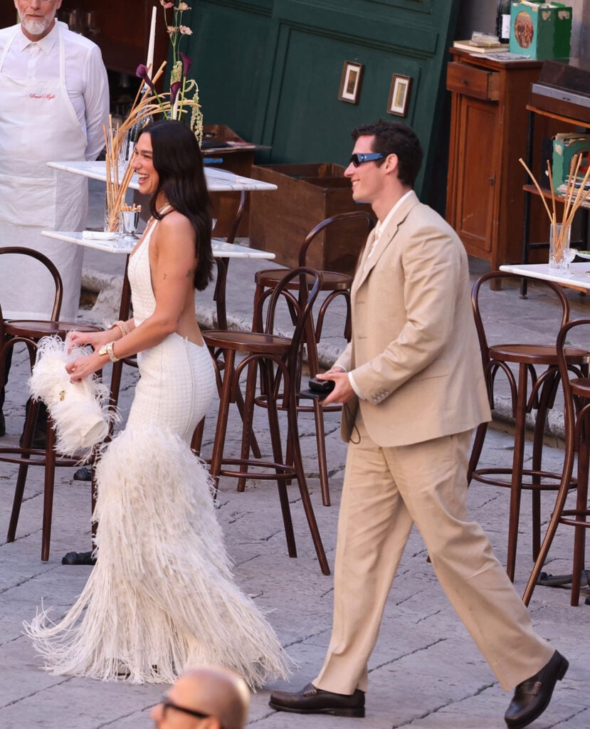 Dua Lipa wearing a custom Bottega Veneta Intrecciato dress with Callum Turner during pre-wedding celebrations in Palermo.