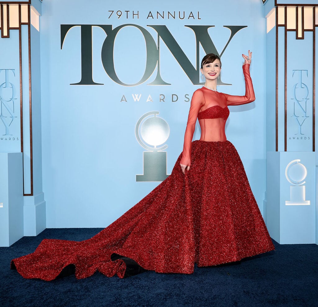 Dylan Mulvaney wears a Christian Siriano red metallic mesh gown at the 2026 Tony Awards.
