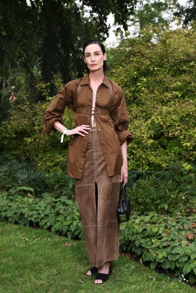 Erin O'Connor wearing a brown Hermès look with a leather harness at the Hermès Maison Bond Street opening in London