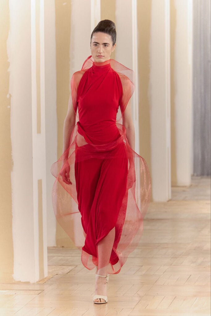 Ernesto Naranjo red draped dress from the designer's collection featuring sheer sculptural detailing