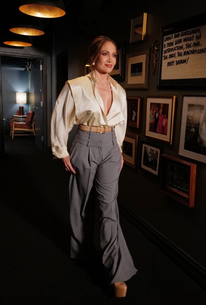 Jennifer Lopez wearing an ivory satin blouse with Viktor & Rolf trousers for Jimmy Kimmel Live! in Los Angeles