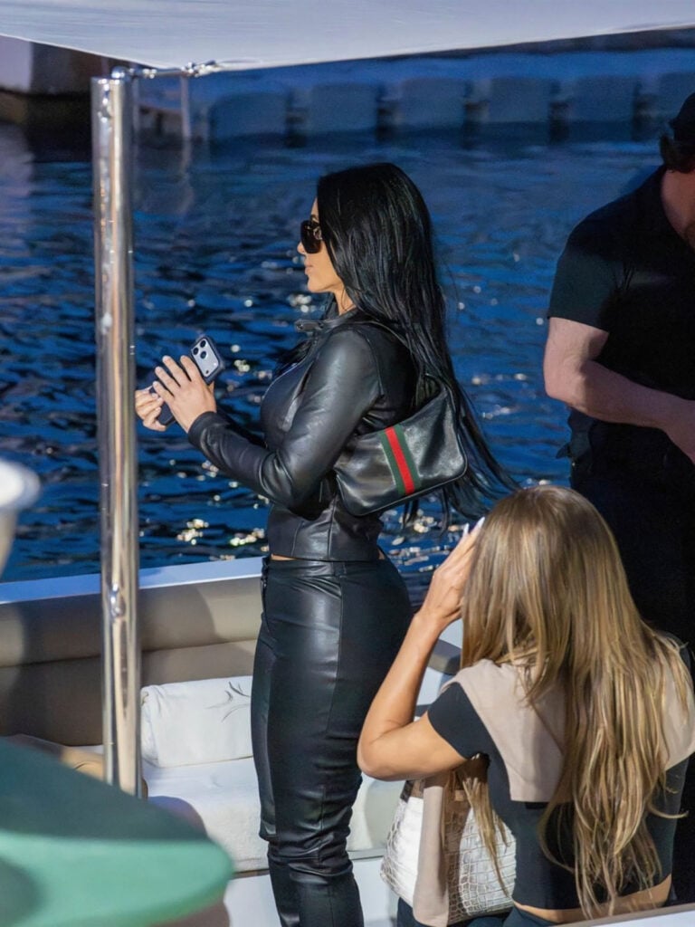 Side view of Kim Kardashian wearing Gucci Generation black leather separates with a Gucci Lunetta shoulder bag in Monaco.