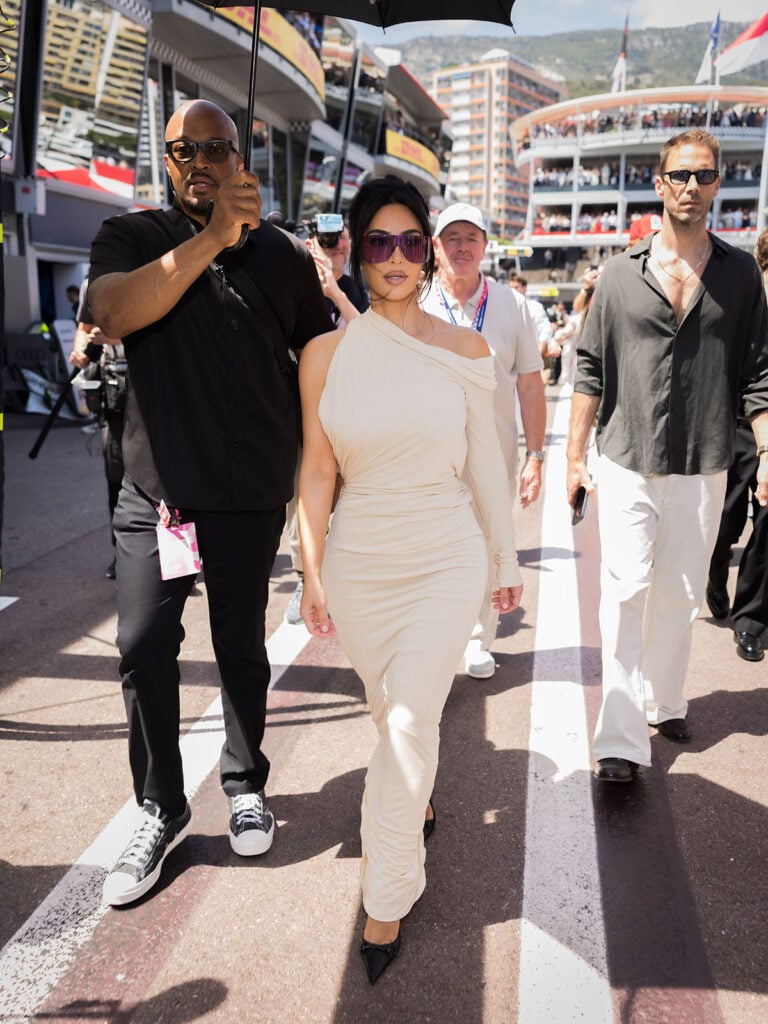 Kim Kardashian wears a custom Gucci cream draped dress at the Monaco Grand Prix on race day in Monaco.