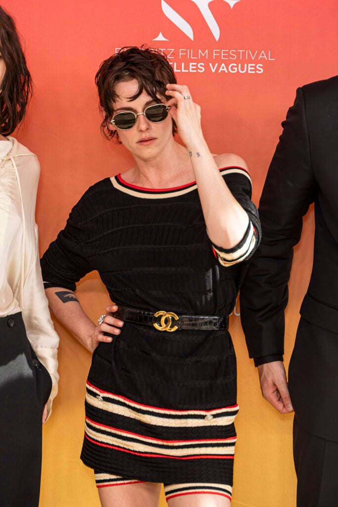 Kristen Stewart arrives at the Biarritz Film Festival wearing a Chanel knit top and biker shorts with loafers and sunglasses.