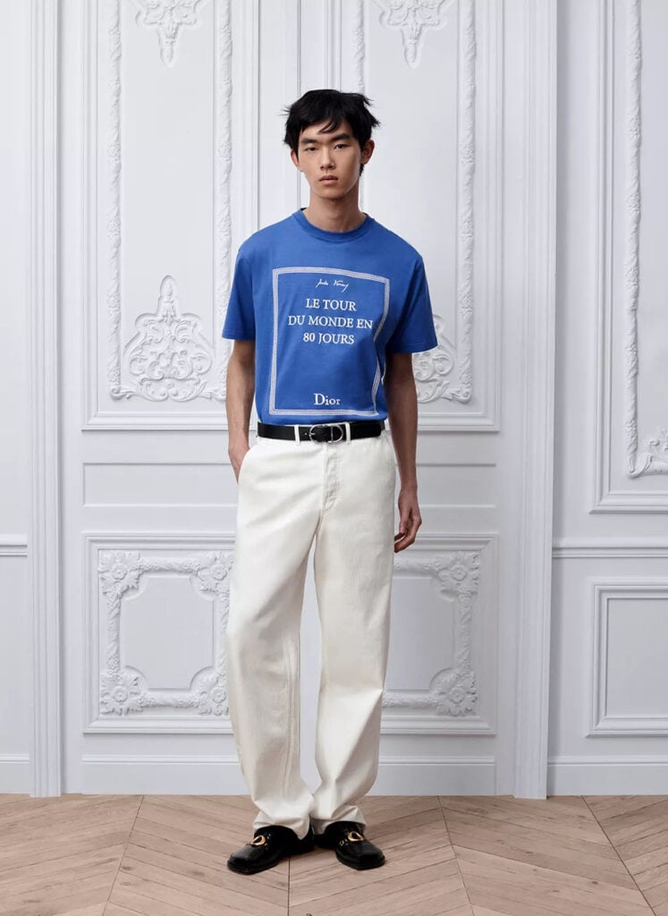 Dior menswear runway look featuring the Le Tour Du Monde En 80 Jours graphic T-shirt.