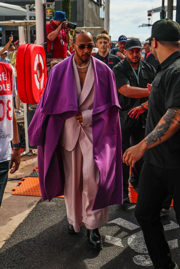 Lewis Hamilton wearing an Issey Miyake Fall 2026 pink suit with a violet overcoat at the Monaco Grand Prix
