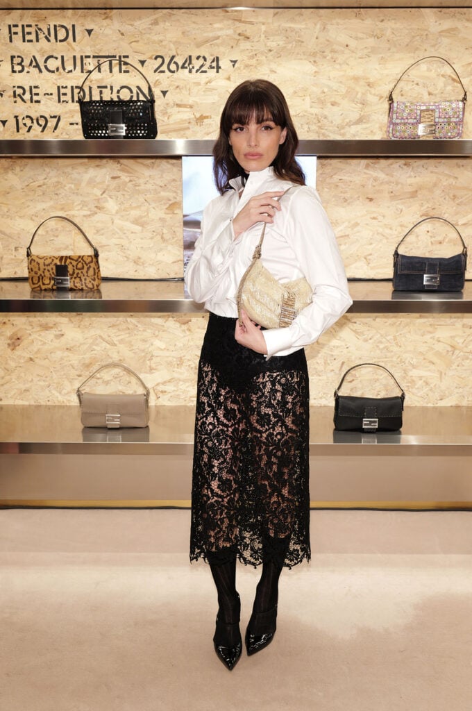 Lux Pascal wearing a white shirt and black lace Fendi skirt at FENDI’s Baguette Re-Edition event in New York City