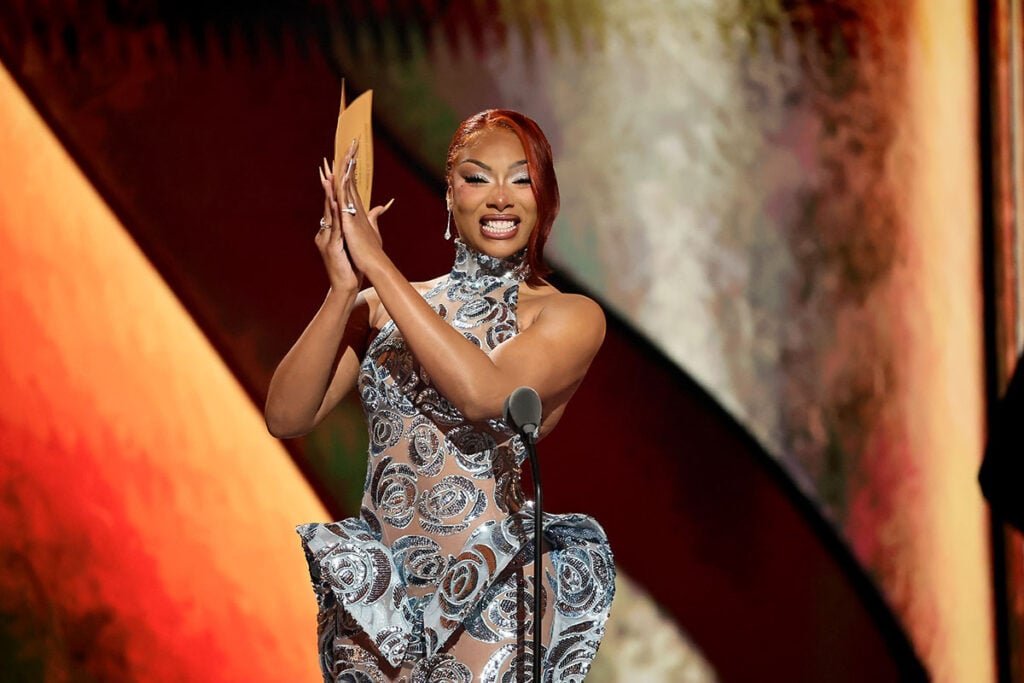 Megan Thee Stallion speaks onstage during The 79th Annual Tony Awards in silver dress