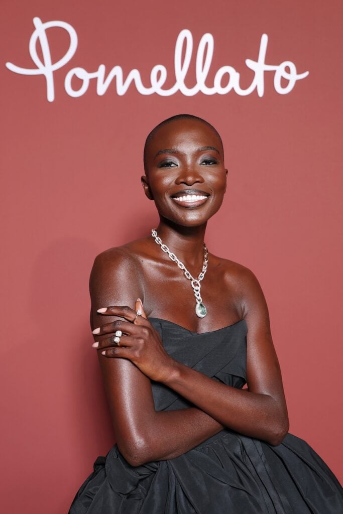 Amina Seck attends "Pomellato, Le Joailler Révolutionnaire" exhibition opening  black gown