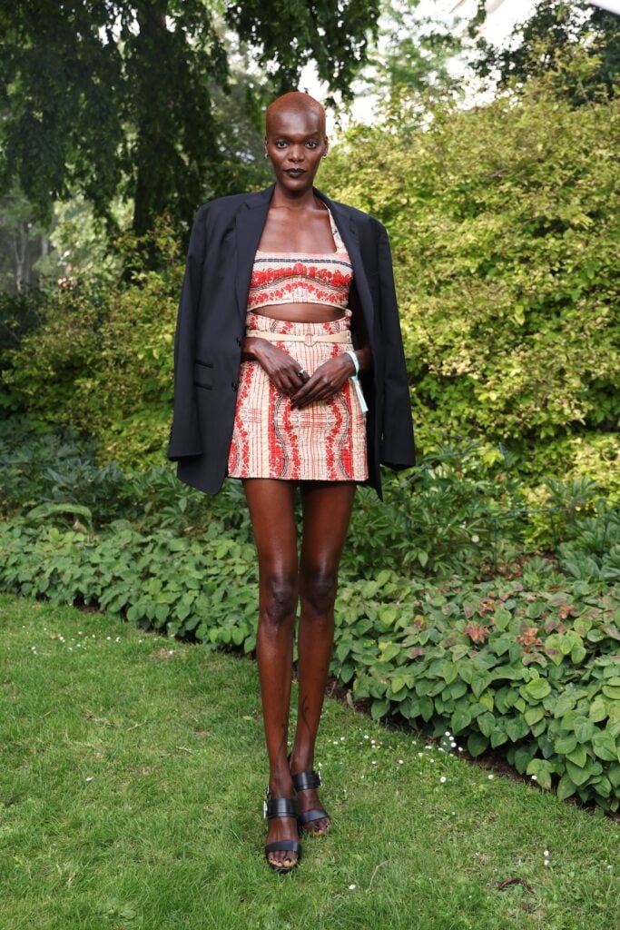 Sheila Atim wearing a Hermès bandeau top, mini skirt and blazer at the Hermès Maison Bond Street opening in London