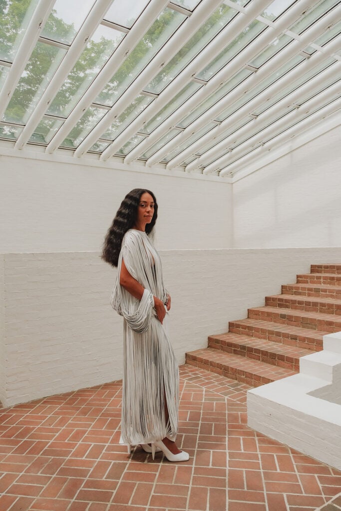Solange Knowles showcases the laser-cut leather detailing of her Calvin Klein Collection dress at The Glass House Summer Party
