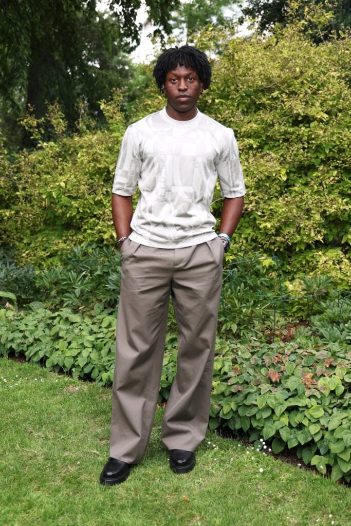 Toheeb Jimoh wearing a tonal Hermès look at the Hermès Maison Bond Street opening in London