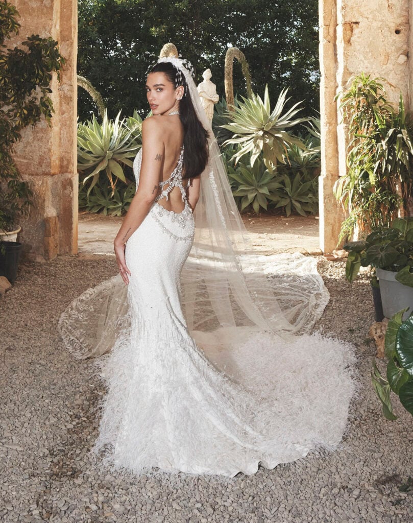 Rear view of Dua Lipa’s custom Chanel Haute Couture wedding gown and embroidered veil at Villa Valguarnera in Sicily.