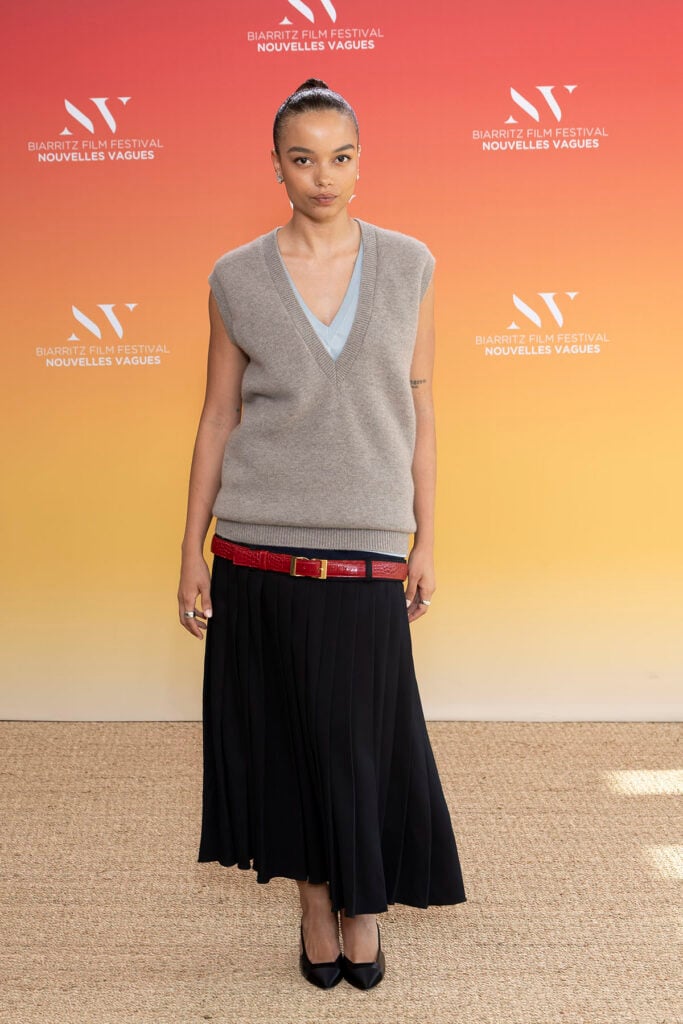 Whitney Peak wears a Chanel Fall 2026 layered knit and pleated skirt at the Nouvelles Vagues International Biarritz Film Festival closing ceremony.