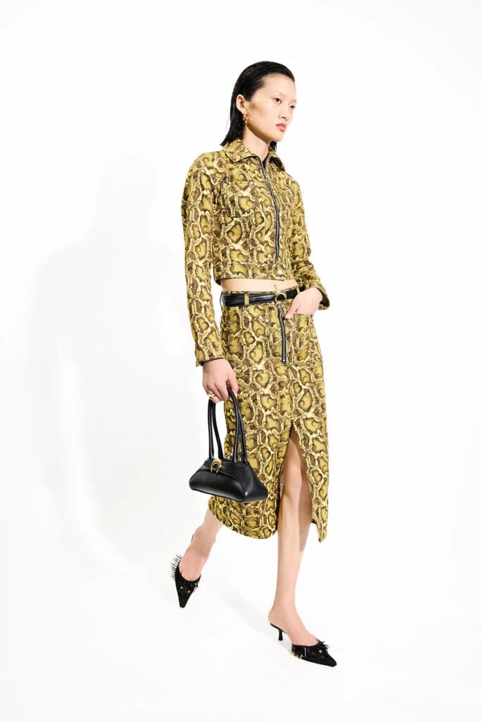 Marine Serre Spring 2026 yellow snake-print jacket and coordinating skirt from the runway collection.