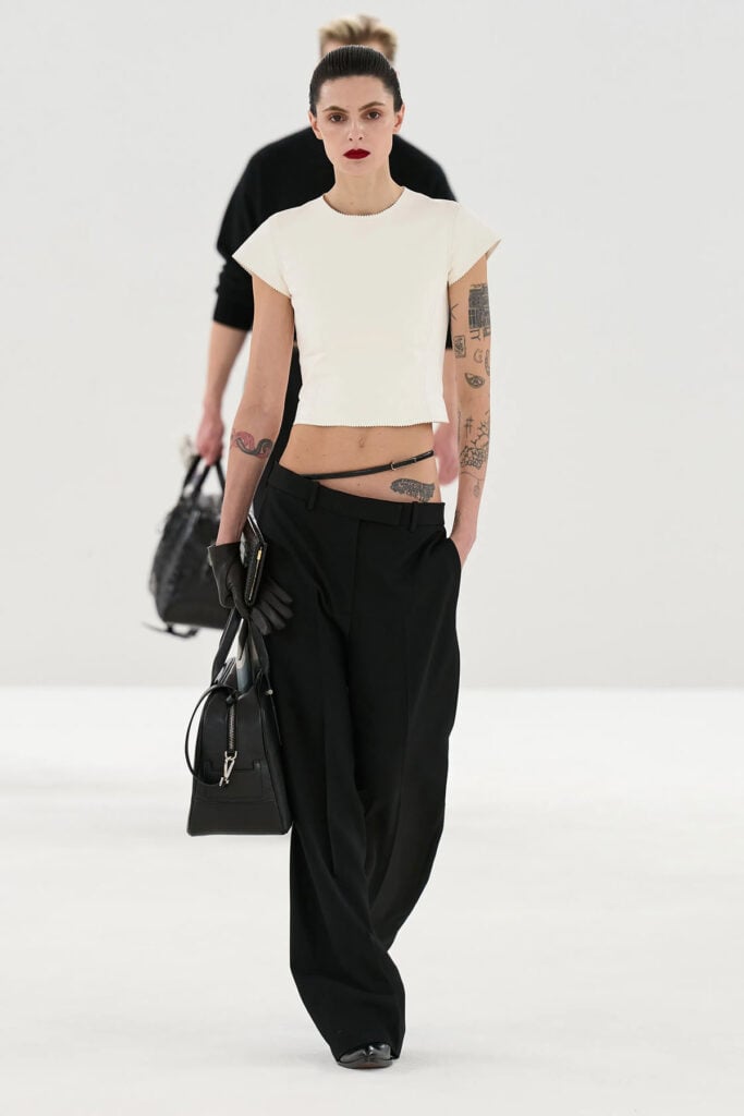 Tom Ford Fall 2026 runway look featuring cropped knit top and slanted tailored trousers.