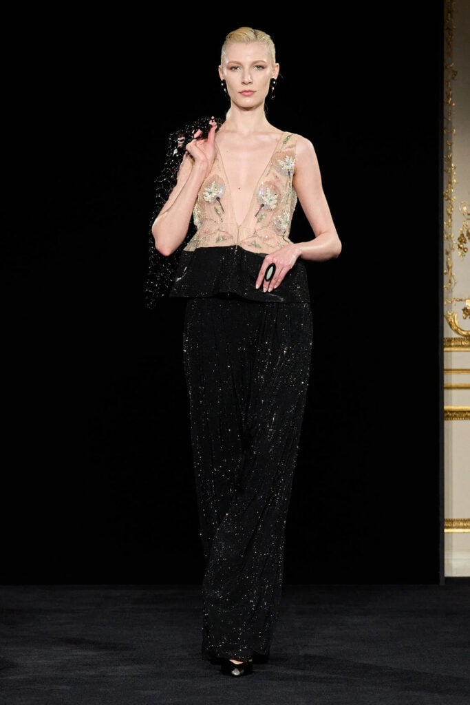 Armani Privé embellished sheer top with black sequinned wide-leg trousers on the runway.