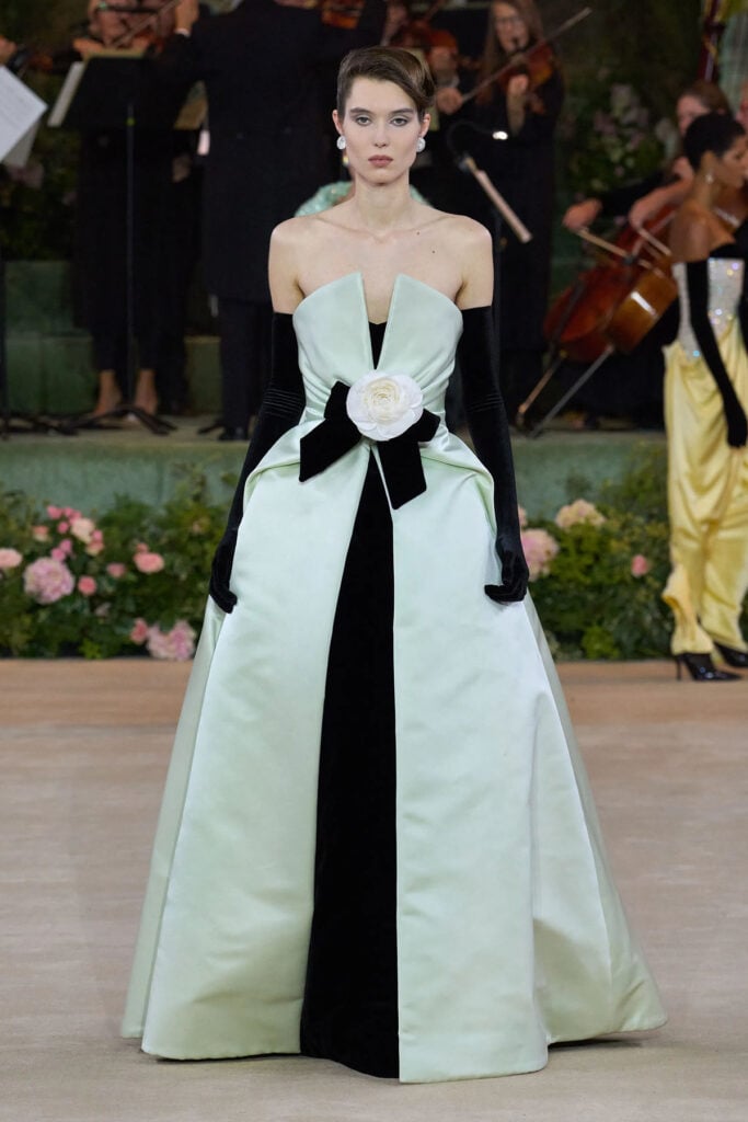 Richard Quinn Spring 2026 black-and-white gown with oversized camellia detail presented on the runway.