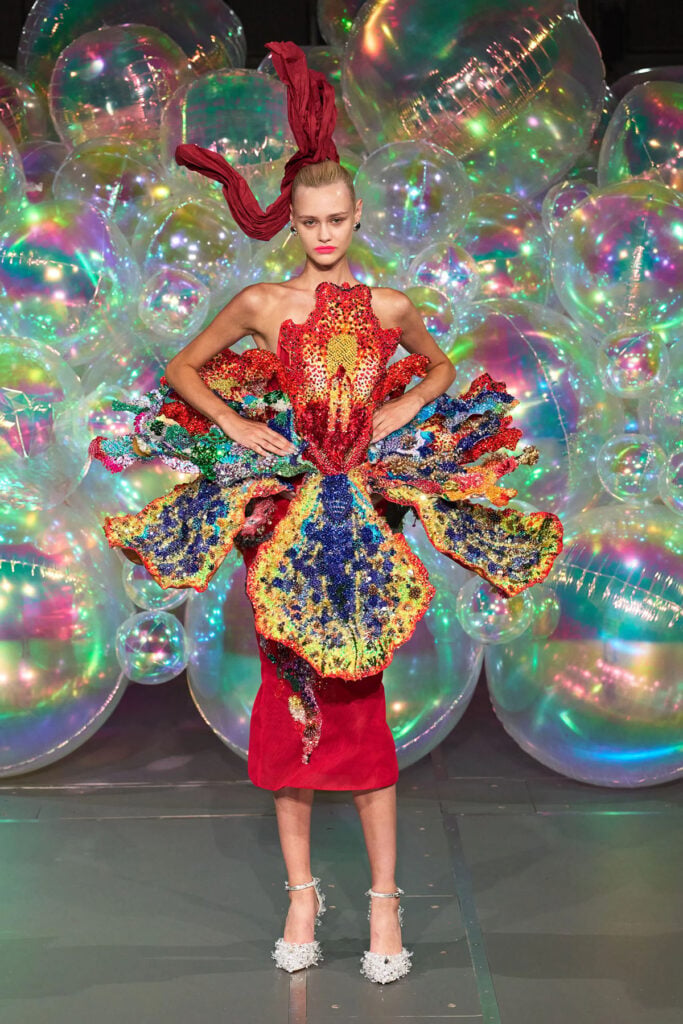 Model wearing the Germanier Fall 2026 Couture sculptural beaded red look in Paris.