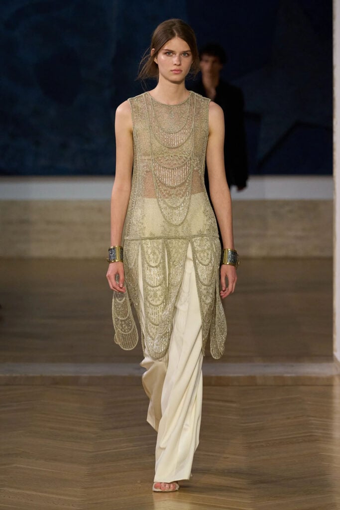 Model walks the Fendi Fall 2026 Couture runway wearing the lace tunic and cream trousers later worn by Nicole Kidman.