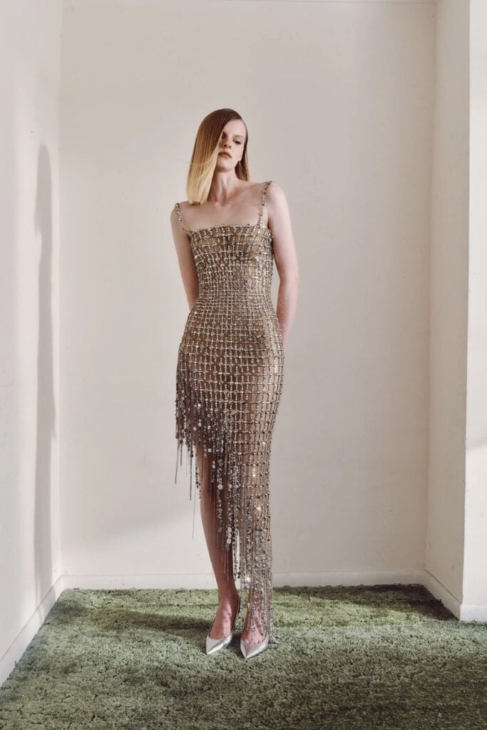Monse Resort 2027 illusion-effect dress with crystal lattice detailing and cascading metal fringe from the look book.