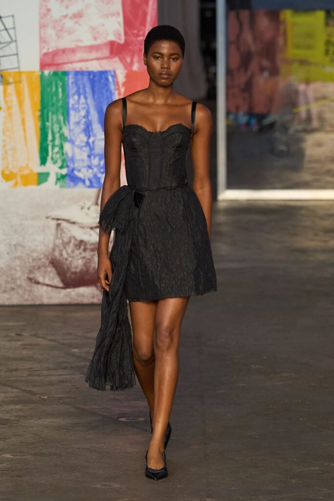 Jason Wu Collection Spring 2026 black bustier mini dress with draped side detail on the runway.