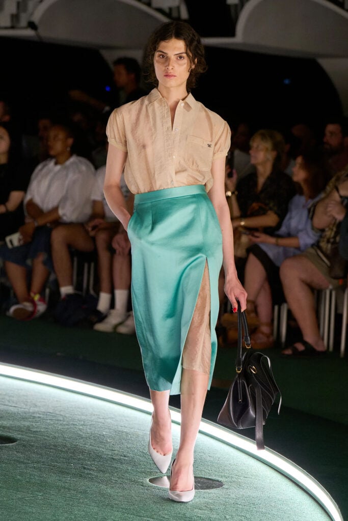 Willy Chavarria Spring 2027 runway look featuring a champagne blouse and aqua satin skirt from the menswear collection.