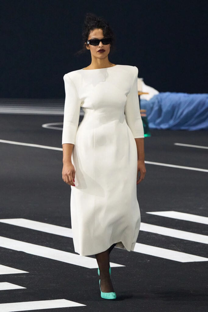 Willy Chavarria Fall 2026 ivory dress with sculpted shoulders and a softly flared skirt.