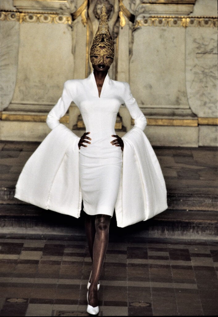 Debra Shaw wearing Givenchy Spring 1997 Haute Couture by Alexander McQueen with a Philip Treacy headpiece on the runway.