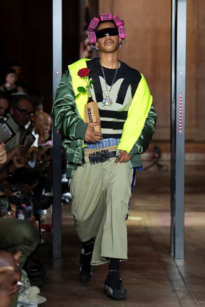 AWGE Spring 2026 runway look featuring the patchwork shirt and Bermuda shorts worn by A$AP Rocky.