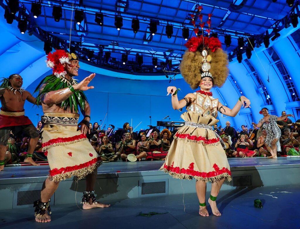 Dwayne Johnson and Catherine Laga'aia perform onstage during the Moana World Premiere 