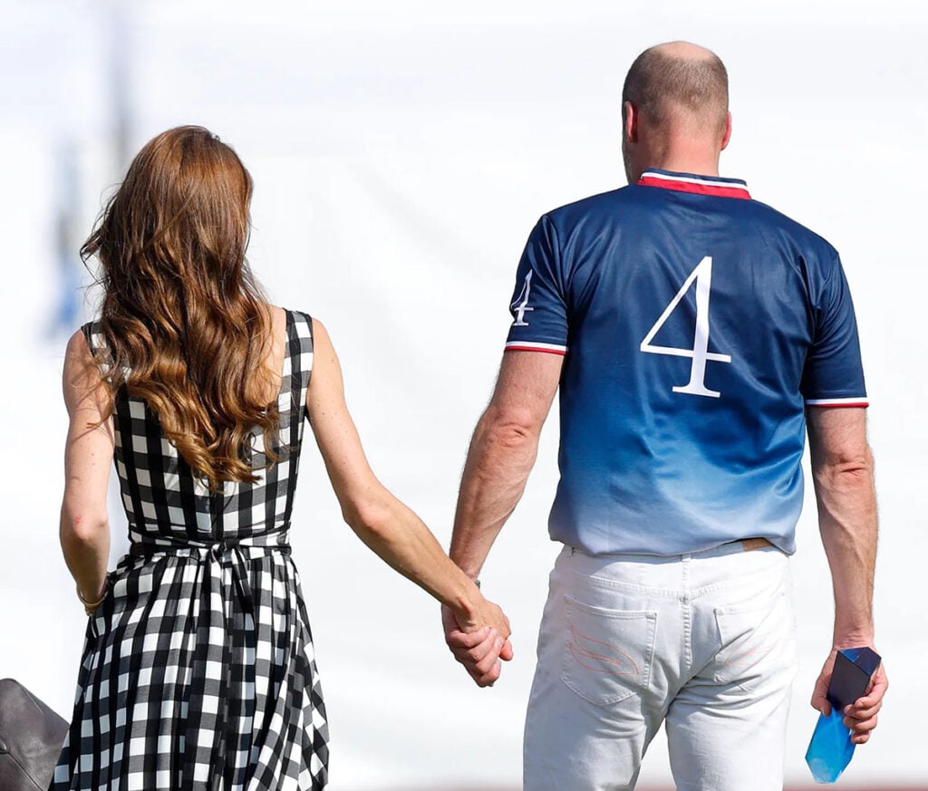 Kate Middleton and Prince William holding hand at the Royal Charity Polo Cup in Windsor wearing a black-and-white Temperley London gingham midi dress.