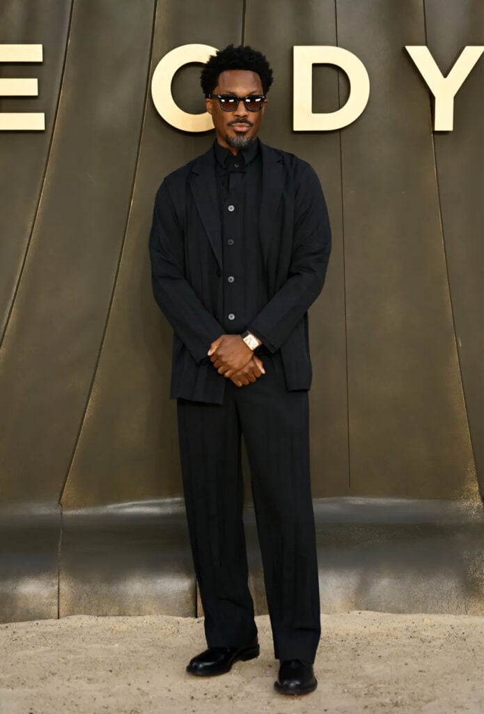 Corey Hawkins wearing an all-black Issey Miyake look at The Odyssey world premiere in London.