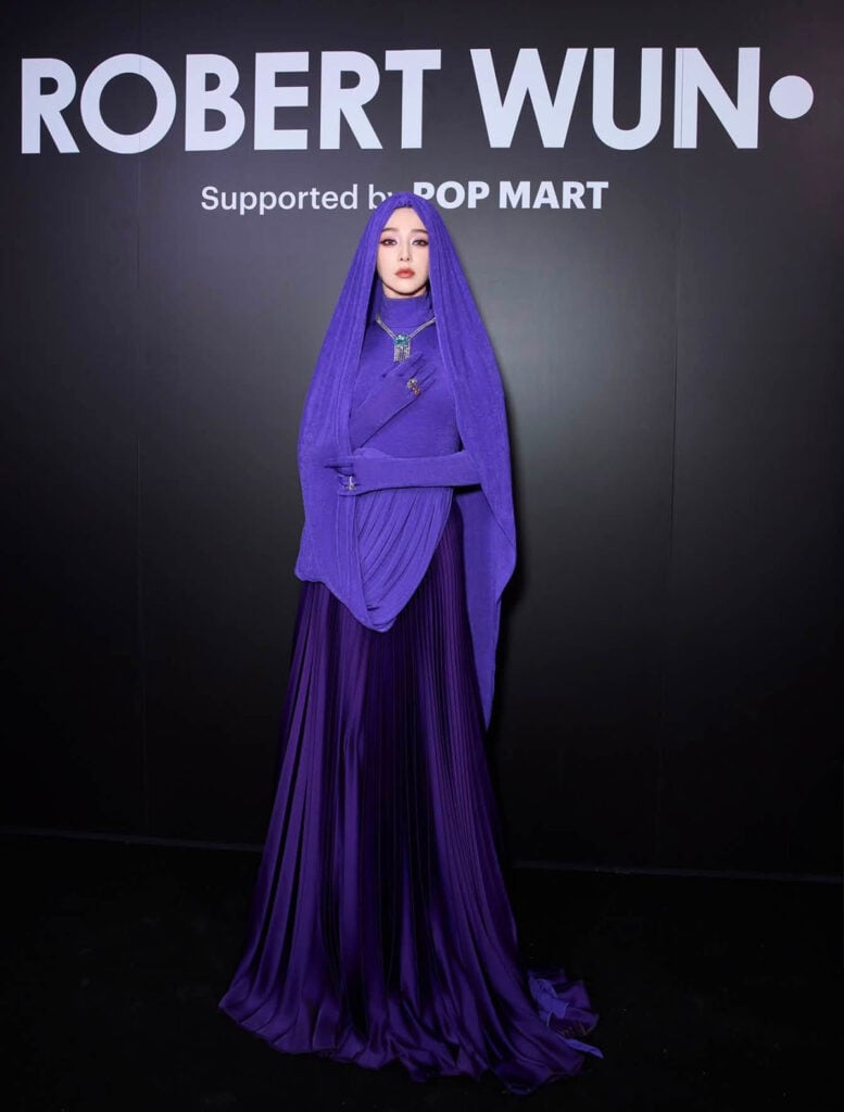 Fan Bingbing attending the Robert Wun Fall 2026 Haute Couture show in a pleated purple hooded gown.