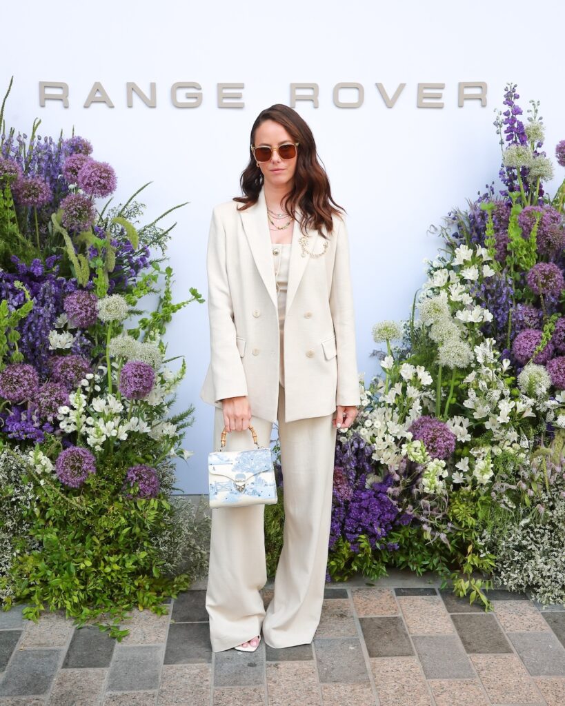 Kaya Scodelario wearing a Maje suit at the Range Rover hospitality suite during the Wimbledon 2026 men's final.