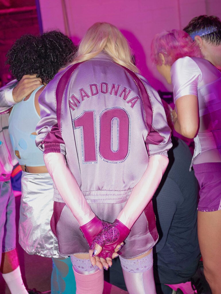 Back view of Madonna's Saint Laurent Teddy jacket with personalised 'Madonna 10' lettering at the FIFA World Cup Final Halftime Show.