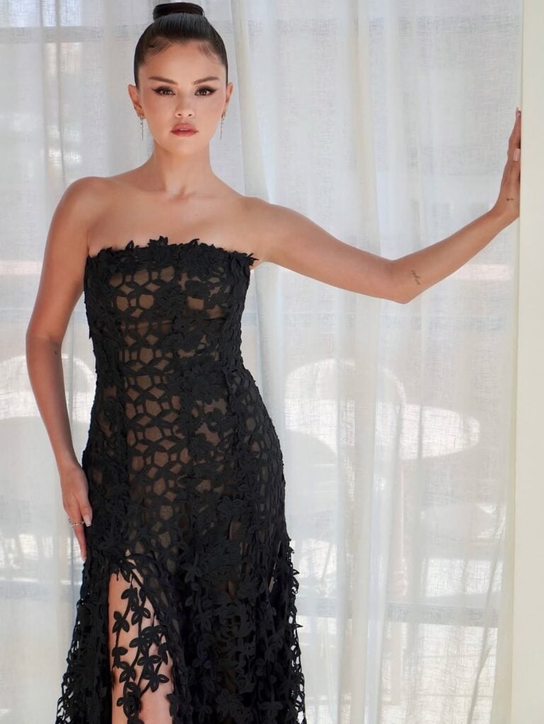 Selena Gomez wears a custom Oscar de la Renta black lace gown at Taylor Swift and Travis Kelce's wedding rehearsal dinner.